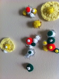 I started putting crochet yo-yos and pom-poms on the wall.